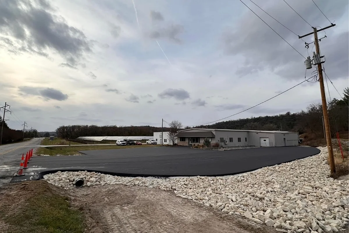 New asphalt approach and entrance apron built up on fresh rock at a commercial building