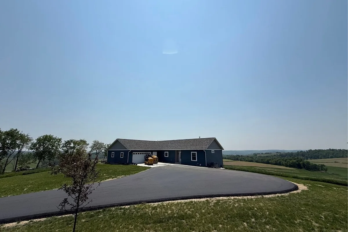 Wide paved circle drive and turnaround at a ranch home overlooking farm valley