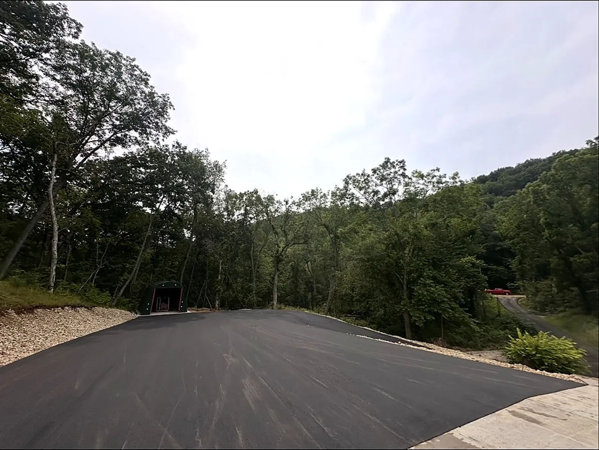 New mat curving up to a poured concrete apron