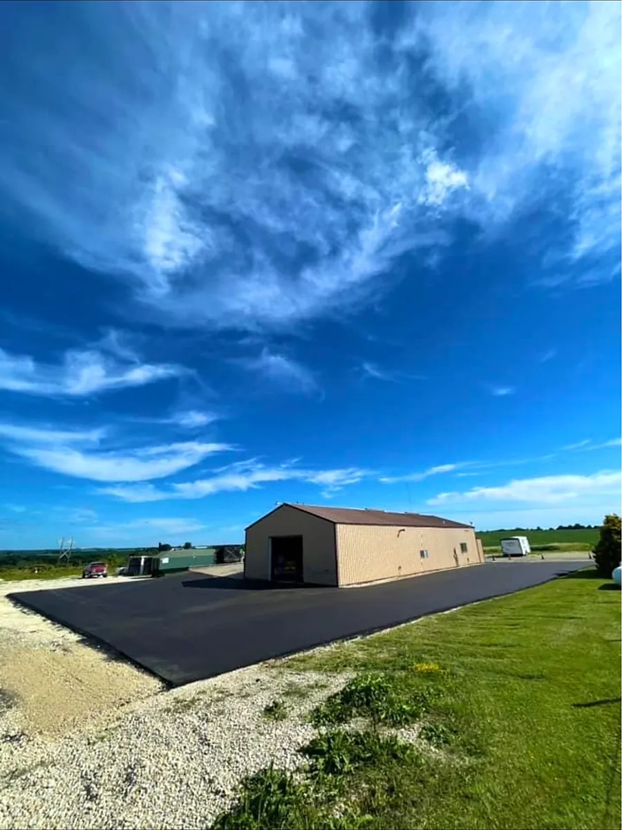 New lot alongside a tan steel commercial building
